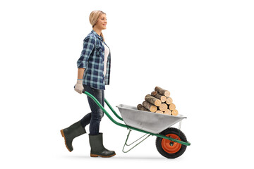 Female worker pushing firewood trunks in a wheelbarrow © Ljupco Smokovski