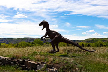 dinosaur looking over valley on bright summer day in Drumheller Alberta Canada