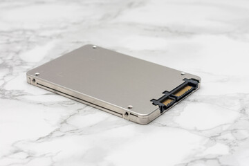 Silver computer hard drive sits on a marble countertop
