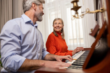 Mature woman having a music class with a male teacher