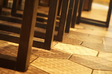 geometric floor tiles and chair legs in warm light