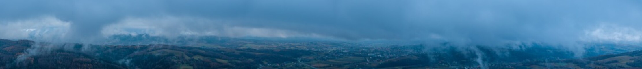 Ultrawide aerial panorama of the landscape with hills and clouds near Strzyżów Poland