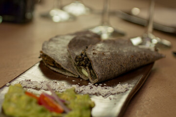 Blue corn tortilla stuffed with cheese, mexican snack quesadillas close-up.