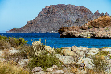 overview of blue ocean bay with rocks and rocky island 