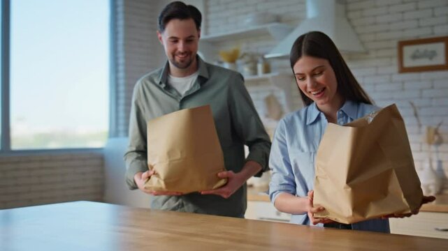 Couple arrived grocery store putting shoppings on kitchen countertop closeup