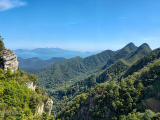 Fototapeta premium Planet Pics Collection a Beauty of Natrue, Lens on The World. Mountain and Forest under clear blue sky.
