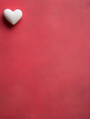 Obraz premium A white heart-shaped object is prominently displayed against a vibrant red wall, symbolizing love and romance for Valentine's Day.