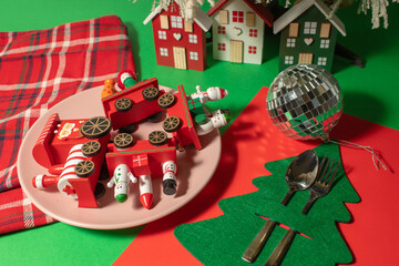 Christmas decorations on a plate on the table. Minimal surrealism