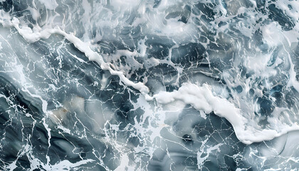 Obraz premium A stunning view of turbulent ocean waves with foamy white crests against a deep blue background.