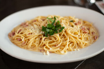 Carbonara pasta, spaghetti with pancetta, egg, hard Parmesan cheese and cream sauce. Traditional Italian cuisine. Pasta alla carbonara.