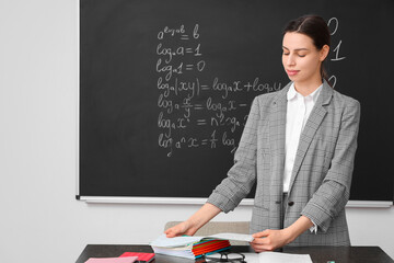 Young female math teacher in classroom