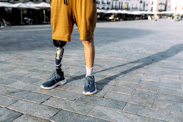 Man with prosthetic leg standing outdoor in casual attire