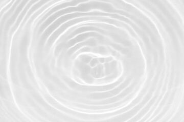 White water with ripples on the surface. Defocus blurred transparent white colored clear calm water surface texture with splashes and bubbles. Water waves with shining pattern texture background.