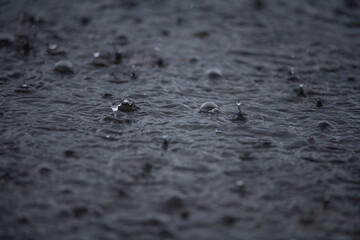Rain. Raindrops background. Rain. Falling raindrops. Water drop splash. Abstract shape out of the water. Raining outside. Water texture.