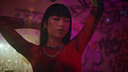 Energetic woman dancing vibrant beats nightclub. Closeup asian clubber nightlife
