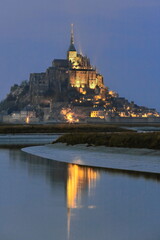 Fototapeta premium Le Mont-Saint-Michel abbey at dusk on a tidal island of the homonymous bay, granite outcrop at the canalized Couesnon River mouth. Normandy-France-080