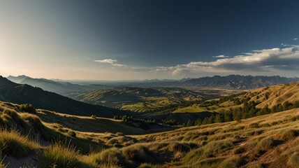 Panoramic view of a valley with mountains and grasslands under a clear sky.