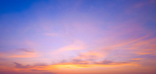 Fototapeta premium Evening sky with yellow and orange cloud on blue horizon sunset sky background after sundown in panoramic view
