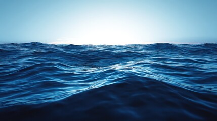 Fototapeta premium A wide shot of a blue ocean with waves, with a bright sun shining on the horizon.