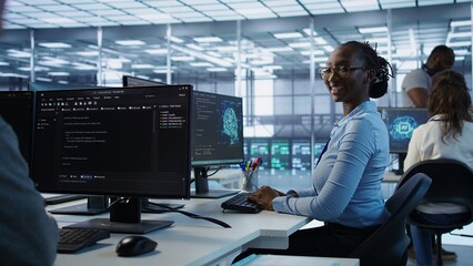 Portrait of smiling woman tasked with doing checkup on server room rows providing computing...