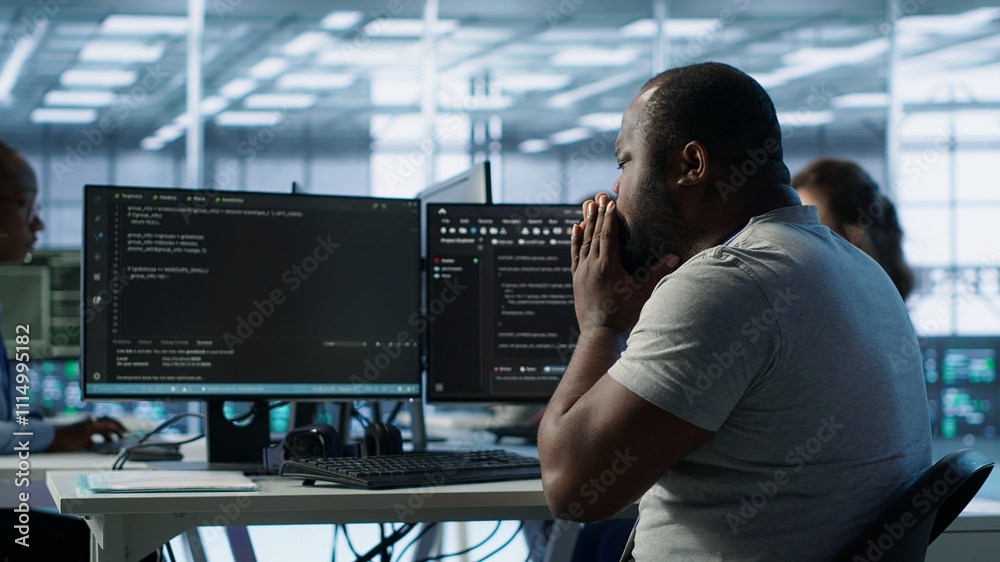 Poster admin working in computer network security data center suffering from cold, sneezing. ill african am