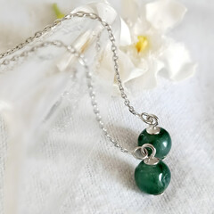 Elegant Green Jade Earrings with Floral Background