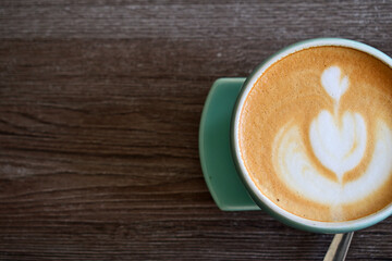 Cup of coffe latte isolated on the wooden table. Half view, top view. Free space, copy space, empty...