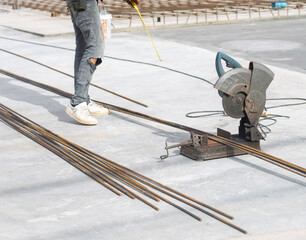 Steel bar cutter in the construction area, there is a technician about to cut steel.