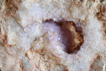 Gemstones and an agate geode with amethyst. A closeup of stones and geologic formation. The...