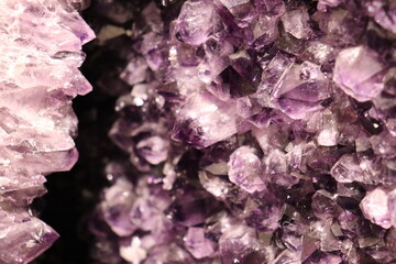 Gemstones and purple amethyst. A closeup of stones and geologic formation. An amethyst geode. The benefits of gem and the amethyst. Minerals and organics elements.