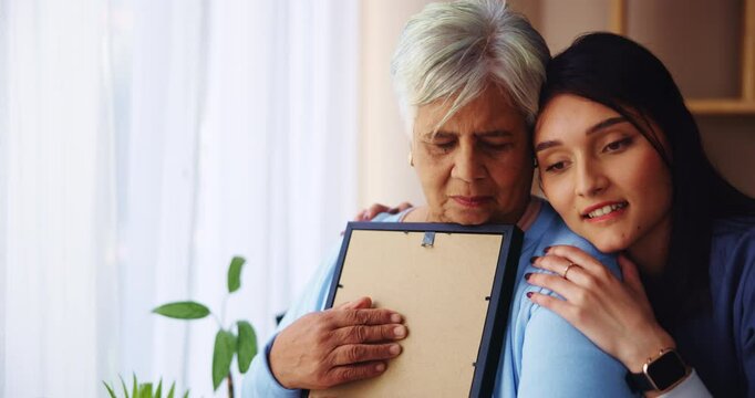 Hug, grandma and woman with picture, smile and remember loss, widow and bonding of family in house. Apartment, embrace and affection for senior person, care and love for granddaughter in home