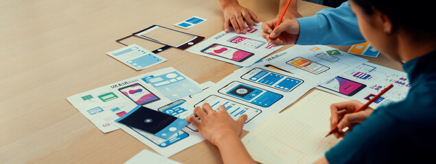 Panorama banner of startup company employee planning on user interface prototype for mobile application or website in office. UX UI designer brainstorm user friendly interface plan. Synergic