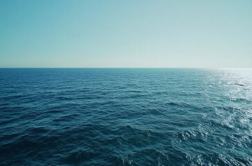Obraz premium A vast and tranquil ocean stretching to the horizon, capturing the endless beauty of the Pacific or Atlantic, creating a perfect wallpaper with negative space for travel and commercial backgrounds.