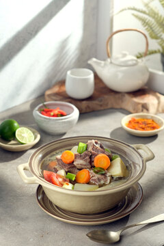 Sop buntut is an Indonesian oxtail soup, a hearty and flavorful dish made from tender, slow-cooked oxtail pieces served in a clear, savory broth.