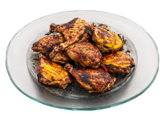 Jamaican jerk chicken spicy and grilled served on a transparent glass plate Caribbean heat