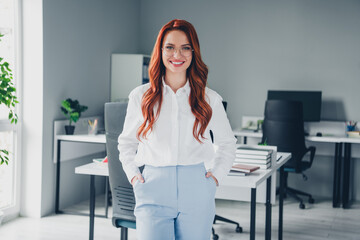 Photo of attractive young woman hands pockets posing wear formalwear modern office room interior...