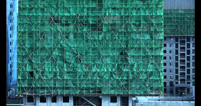 Construction site safety netting sways in the wind