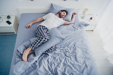 Top view photo of funky funny mature guy sleepwear pajama lying bed indoors home house bedroom