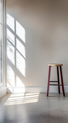 Wooden stool in a sunlit room with shadow patterns on the wall and floor