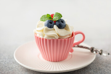 Homemade cupcakes with whipped cream garnished fresh berries for Holidays