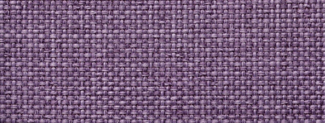 Fototapeta premium Texture violet background from woven textile material with wicker pattern, macro. Structure vintage purple fabric