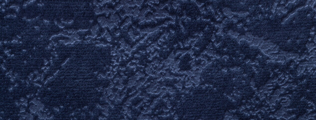 Texture velvet navy blue background from soft upholstery textile material, macro. Abstract velour denim fabric