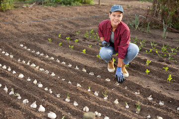 Woman farmer planting seeds in the garden on the farm. Planting seeds and fertilizing the land. Farmer grows organic natural food