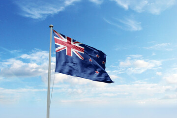 Waving flag of New Zealand in blue sky. New Zealand flag for Republic Day and Independence Day.