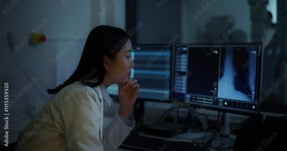 Aufkleber Professional Radiologist Studies Patient X-rays in an Advanced Software on a Computer Display in a Darkened Room. Asian Medical Specialist Making an Assessment of a Critical Medical Data