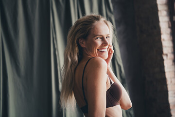 Naklejka premium No filter studio photo of pretty shiny woman wear lingerie enjoying self acceptance isolated khaki cloth background