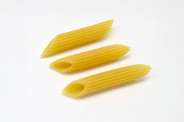 raw Penne Rigate, uncooked Italian Pasta, isolated on white background, full depth of field