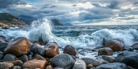 Obraz premium Boulders create a stunning wave breaker in the foreground, showcasing the power and beauty of nature with dramatic waves crashing against the rocky barrier in this captivating scene.