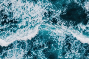 Fototapeta premium Aerial view of blue and turquoise ocean waves creating patterns