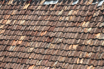 Close-up view of aged, weathered clay roof tiles. Rich texture and history. Awe-Inspiring Texture and History of Ancient Roof Tiles.